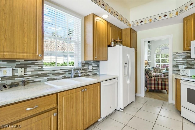 2783 Island Pond Ln, Naples, FL 34119 - kitchen with backsplash, a healthy amount of sunlight, a sink, and white appliances