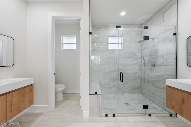 full bath with recessed lighting, a shower stall, toilet, vanity, and baseboards
