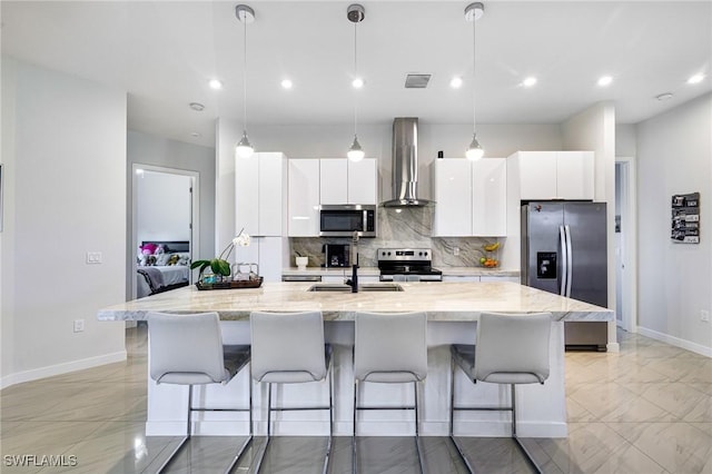 1990 47th Ave NE, Naples, FL 34120 - kitchen featuring visible vents, wall chimney range hood, a sink, appliances with stainless steel finishes, and white cabinetry