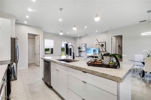 1990 47th Ave NE, Naples, FL 34120 - kitchen with white cabinets, a large island with sink, a sink, marble finish floor, and appliances with stainless steel finishes