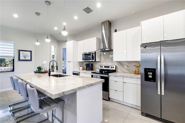 1990 47th Ave NE, Naples, FL 34120 - kitchen with marble finish floor, stainless steel appliances, a sink, wall chimney exhaust hood, and white cabinetry