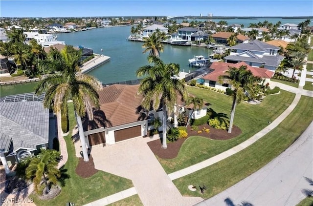 birds eye view of property with a water view and a residential view