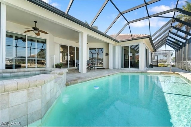 pool with glass enclosure, a ceiling fan, and a patio