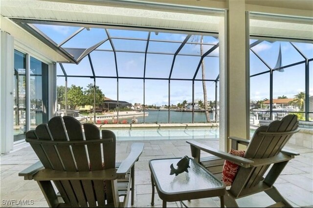 view of patio / terrace with a water view and glass enclosure