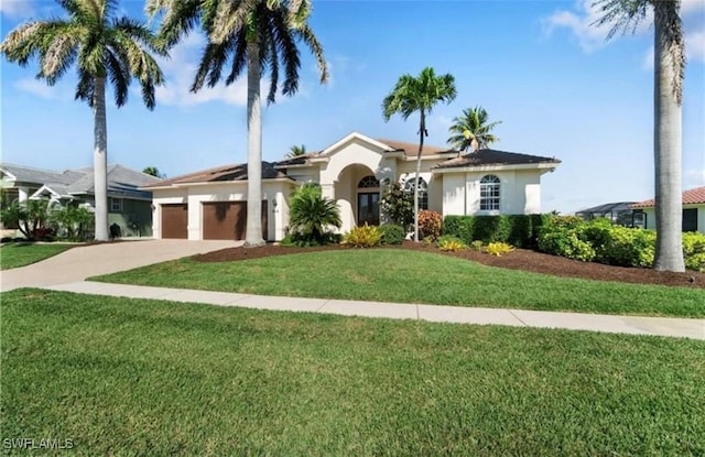 view of front of home featuring a garage, stucco siding, a front lawn, and concrete driveway