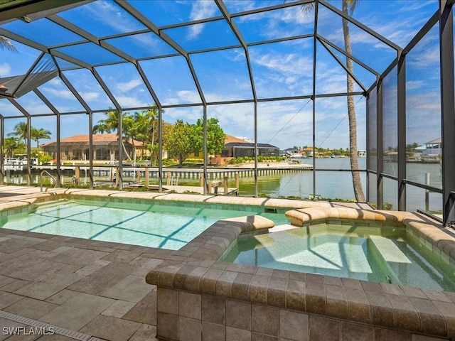 view of swimming pool with glass enclosure, a pool with connected hot tub, and a water view