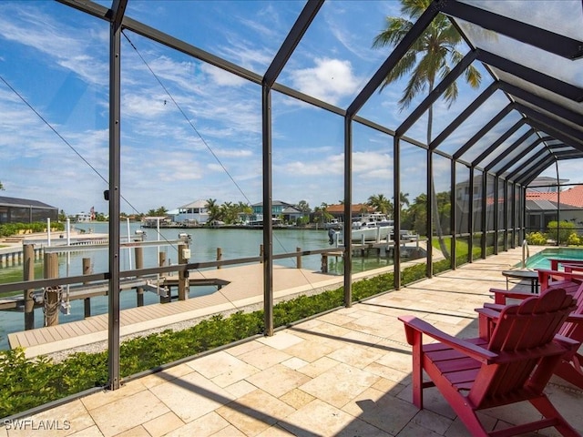 view of patio / terrace with a dock, an outdoor pool, glass enclosure, a water view, and boat lift