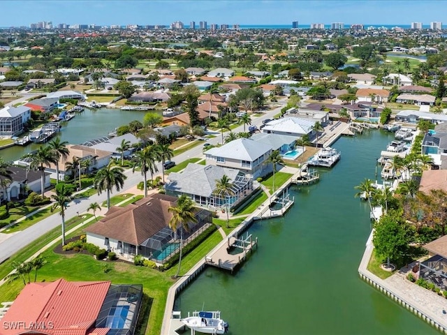 aerial view with a water view, a residential view, and a view of city