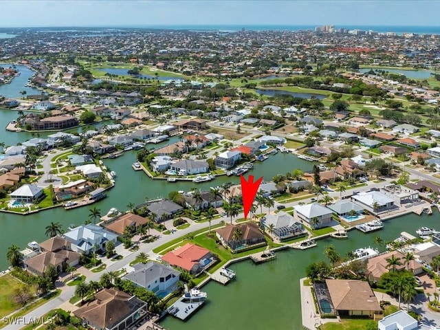 drone / aerial view featuring a residential view and a water view