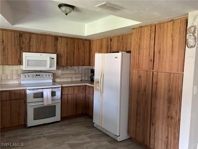 191 Round Key Cir Unit D2, Naples, FL 34112 - kitchen with white appliances, brown cabinetry, and light countertops