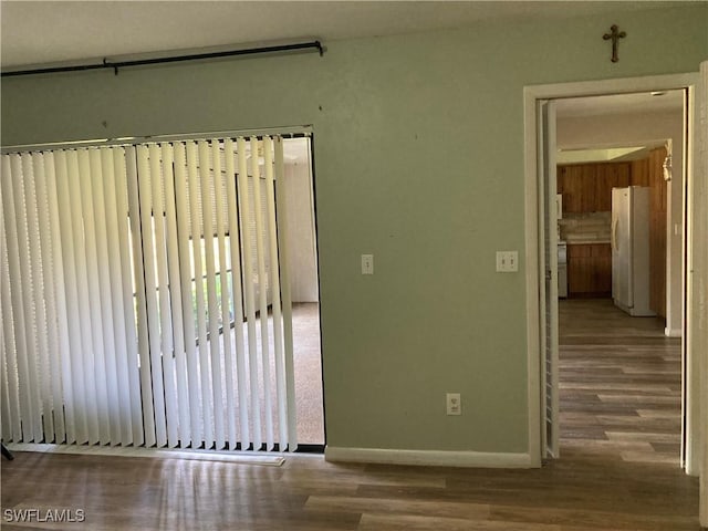 191 Round Key Cir Unit D2, Naples, FL 34112 - spare room featuring wood finished floors and baseboards