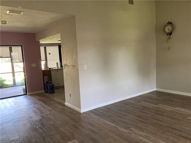 191 Round Key Cir Unit D2, Naples, FL 34112 - spare room featuring dark wood finished floors and baseboards