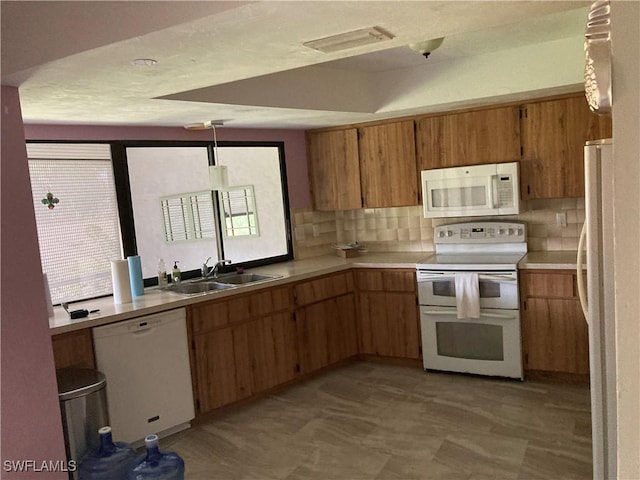 191 Round Key Cir Unit D2, Naples, FL 34112 - kitchen with white appliances, backsplash, and light countertops