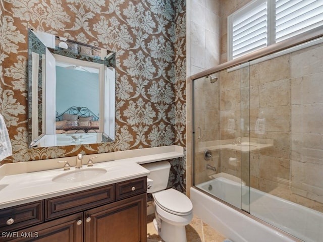 28561 Calabria Ct Unit 102, Naples, FL 34110 - ensuite bathroom featuring wallpapered walls, toilet, shower / bath combination with glass door, and vanity
