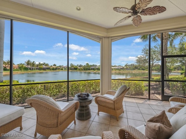 28561 Calabria Ct Unit 102, Naples, FL 34110 - sunroom / solarium featuring a water view, a ceiling fan, tile patterned floors, plenty of natural light, and a textured ceiling