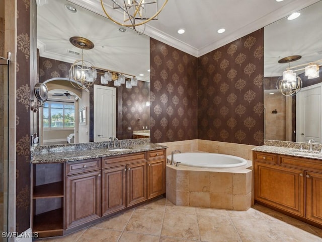 28561 Calabria Ct Unit 102, Naples, FL 34110 - bathroom with a chandelier, crown molding, wallpapered walls, a garden tub, and two vanities