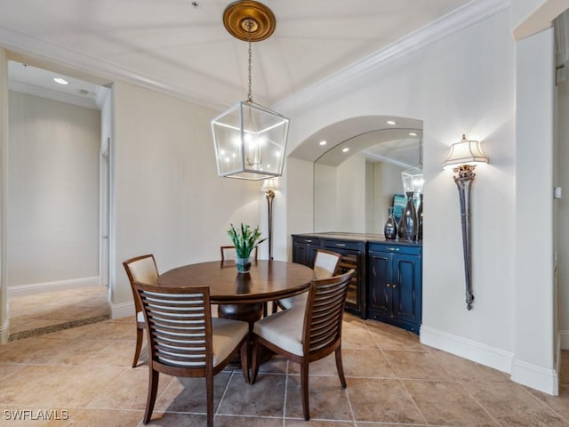 28561 Calabria Ct Unit 102, Naples, FL 34110 - dining space featuring crown molding, wine cooler, baseboards, a chandelier, and recessed lighting