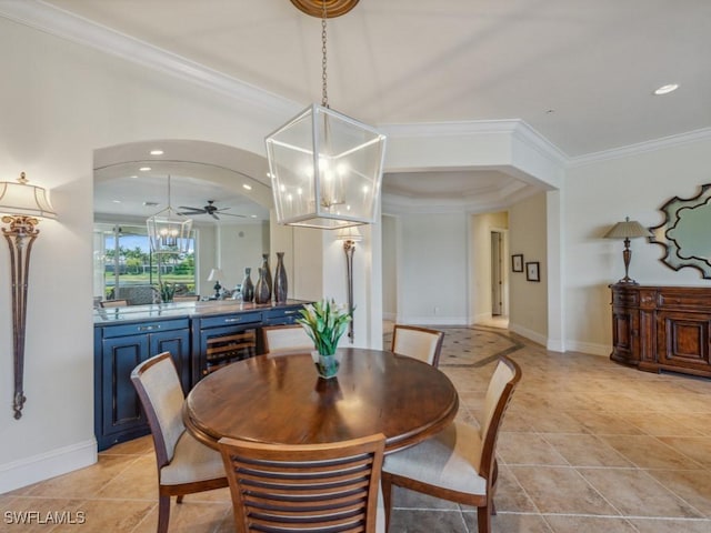 28561 Calabria Ct Unit 102, Naples, FL 34110 - dining room with wine cooler, a ceiling fan, crown molding, light tile patterned floors, and a chandelier