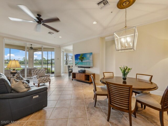 28561 Calabria Ct Unit 102, Naples, FL 34110 - dining space featuring baseboards, crown molding, a chandelier, light tile patterned floors, and ceiling fan