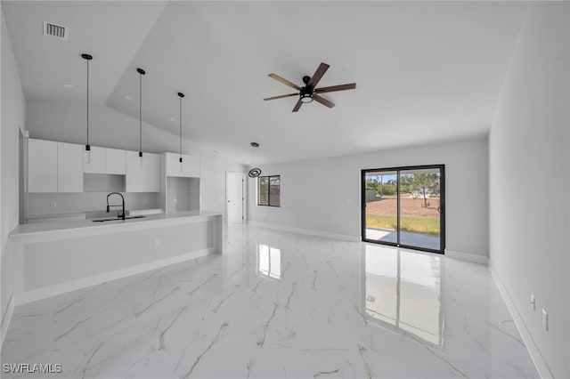 2603 36th St SW, Lehigh Acres, FL 33976 - unfurnished living room featuring a sink, light marble finish flooring, ceiling fan, and high vaulted ceiling