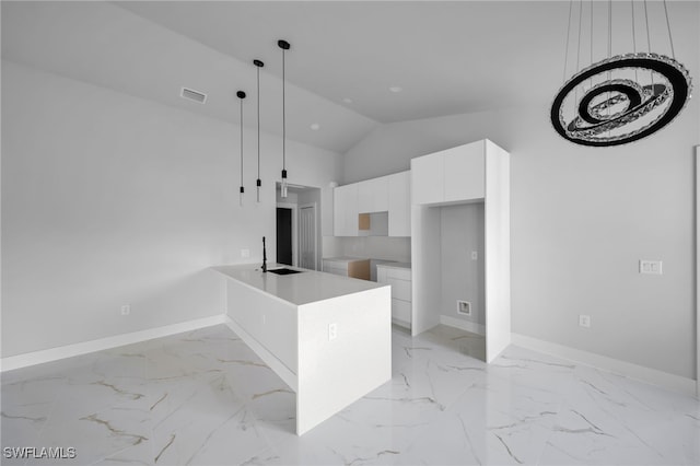 2603 36th St SW, Lehigh Acres, FL 33976 - kitchen with modern cabinets, white cabinetry, a peninsula, a sink, and baseboards