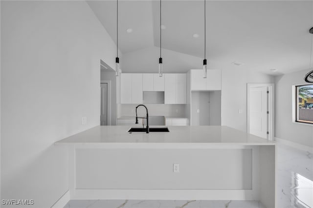 2603 36th St SW, Lehigh Acres, FL 33976 - kitchen with light marble finish flooring, modern cabinets, white cabinetry, a sink, and a peninsula