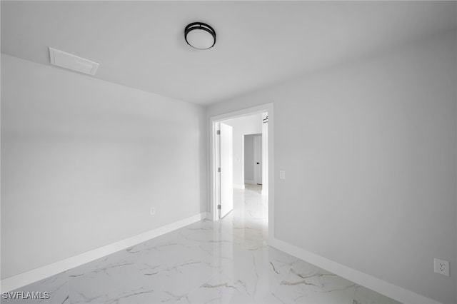 2603 36th St SW, Lehigh Acres, FL 33976 - spare room with light marble finish floors, baseboards, and attic access