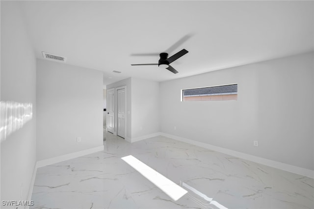 2603 36th St SW, Lehigh Acres, FL 33976 - spare room featuring marble finish floors, baseboards, and a ceiling fan