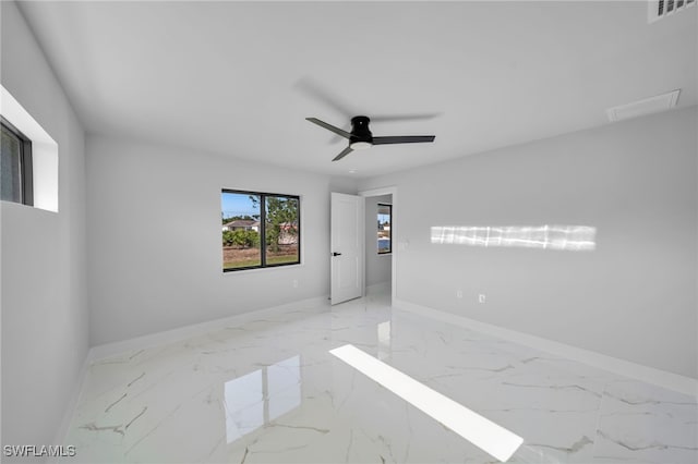 2603 36th St SW, Lehigh Acres, FL 33976 - unfurnished room featuring baseboards, marble finish floors, and ceiling fan
