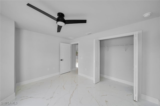 2603 36th St SW, Lehigh Acres, FL 33976 - unfurnished bedroom with marble finish floors, baseboards, a closet, and a ceiling fan
