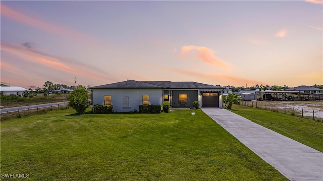 7717 16th Ter, Labelle, FL 33935 - view of front of house featuring a garage, concrete driveway, and stucco siding