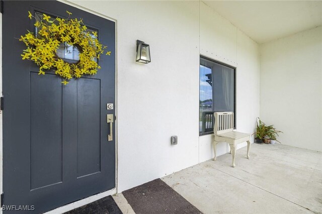 7717 16th Ter, Labelle, FL 33935 - view of exterior entry with stucco siding