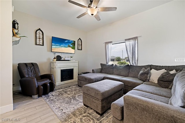 7717 16th Ter, Labelle, FL 33935 - living area with ceiling fan, light wood-style floors, a fireplace, and baseboards
