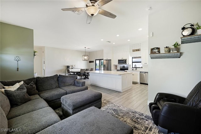7717 16th Ter, Labelle, FL 33935 - living area featuring ceiling fan, light wood-style floors, and recessed lighting