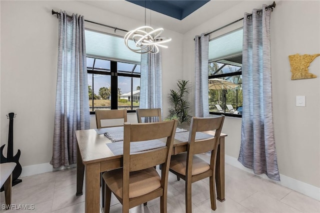 137 SE 23rd Ter, Cape Coral, FL 33990 - dining area featuring baseboards, a notable chandelier, and light tile patterned floors