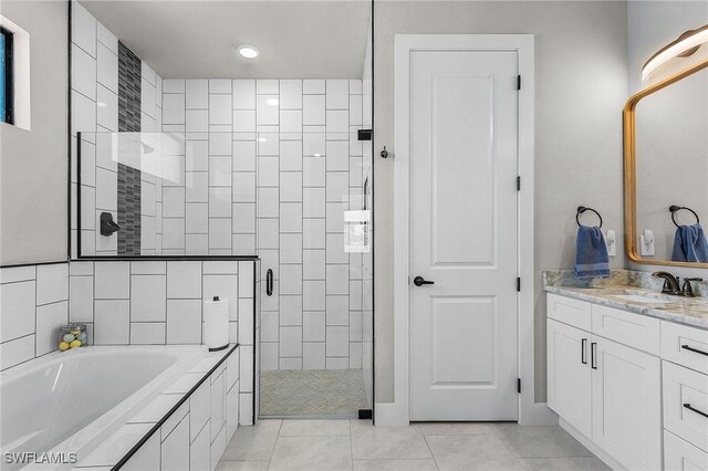 137 SE 23rd Ter, Cape Coral, FL 33990 - bathroom with a shower stall, a bath, tile patterned flooring, and vanity