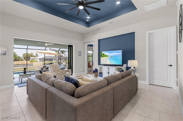 137 SE 23rd Ter, Cape Coral, FL 33990 - living room featuring light tile patterned floors, baseboards, recessed lighting, a ceiling fan, and a raised ceiling