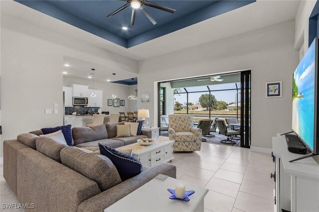 137 SE 23rd Ter, Cape Coral, FL 33990 - living area with a ceiling fan, light tile patterned floors, a towering ceiling, baseboards, and recessed lighting