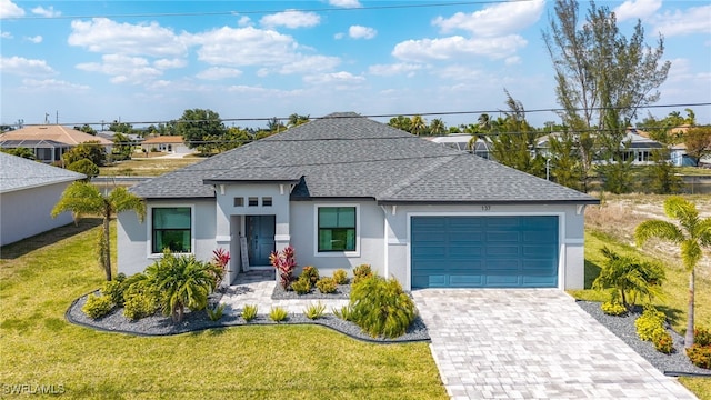 137 SE 23rd Ter, Cape Coral, FL 33990 - view of front of house with a front lawn, driveway, a shingled roof, a garage, and stucco siding