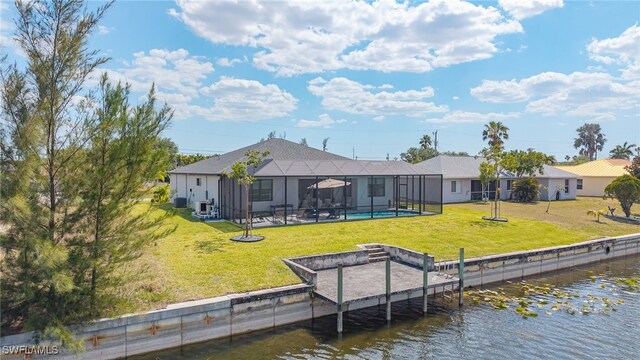 137 SE 23rd Ter, Cape Coral, FL 33990 - rear view of house featuring a lawn, an outdoor pool, glass enclosure, and a water view