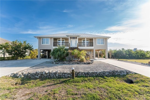 24343 Pirate Harbor Blvd, Punta Gorda, FL 33955 - beach home featuring driveway, a carport, stairway, and metal roof