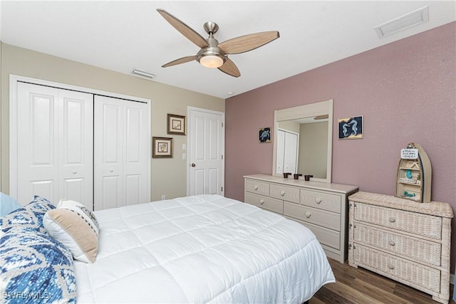 24343 Pirate Harbor Blvd, Punta Gorda, FL 33955 - bedroom with a closet, visible vents, dark wood-style floors, and ceiling fan