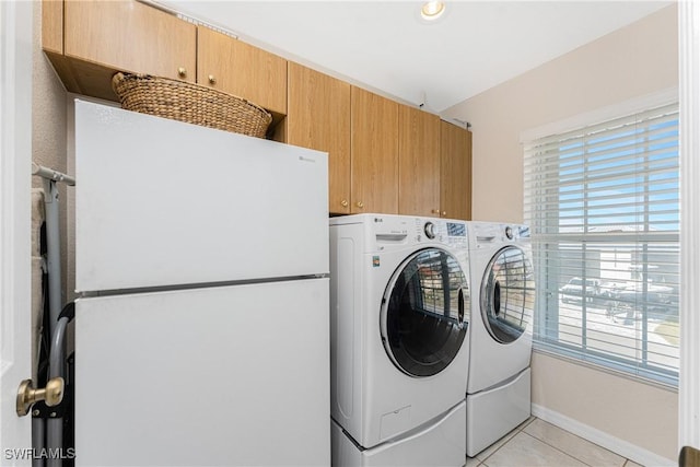 24343 Pirate Harbor Blvd, Punta Gorda, FL 33955 - washroom with plenty of natural light, independent washer and dryer, light tile patterned floors, and cabinet space