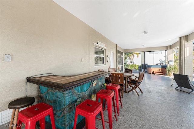 24343 Pirate Harbor Blvd, Punta Gorda, FL 33955 - sunroom / solarium with speckled floor, a textured wall, and a hot tub