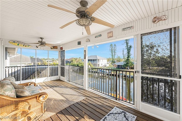 24343 Pirate Harbor Blvd, Punta Gorda, FL 33955 - sunroom with a residential view, a water view, ceiling fan, and wood-type flooring