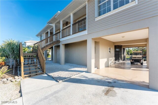 24343 Pirate Harbor Blvd, Punta Gorda, FL 33955 - exterior space featuring a carport and stairway