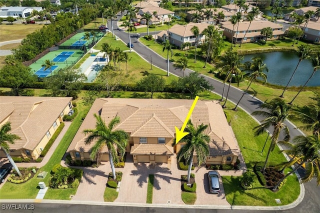 birds eye view of property featuring a water view and a residential view