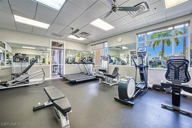 workout area with visible vents, a ceiling fan, and a paneled ceiling