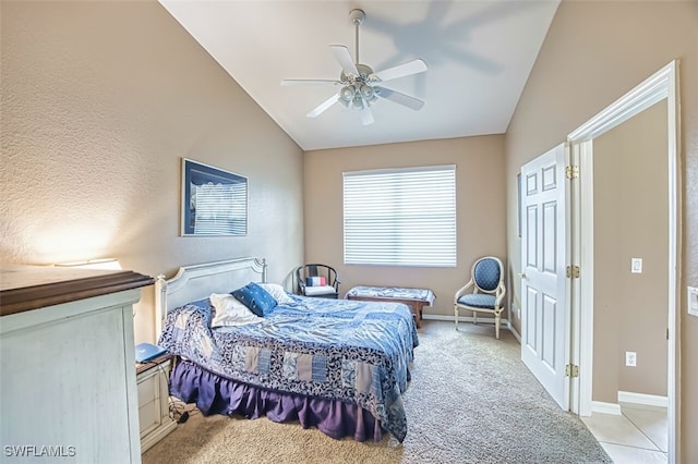 bedroom featuring a ceiling fan, light carpet, baseboards, and lofted ceiling
