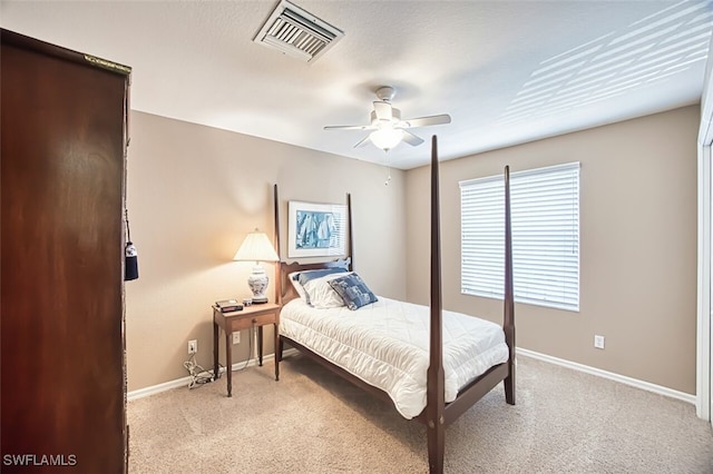 bedroom with light colored carpet, baseboards, a ceiling fan, and visible vents